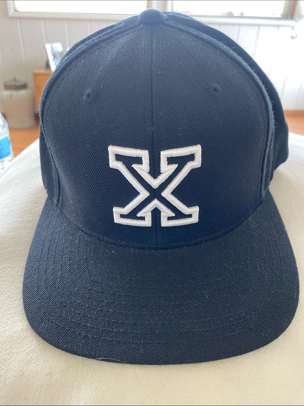 Black Baseball Cap with White 'X' Logo